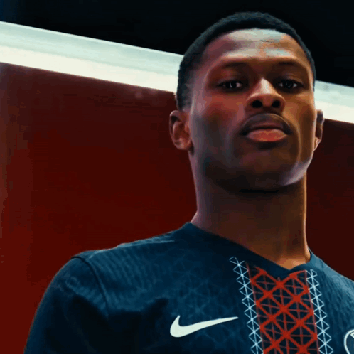A Man Wearing A Nike Shirt That Says Paris GIF