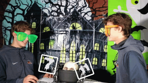 A Man Wearing A Nike Sweatshirt Is Standing Next To Another Man Wearing Green Glasses GIF
