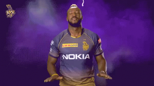 A Man Wearing A Nokia Shirt Stands In Front Of A Purple And Yellow Background GIF