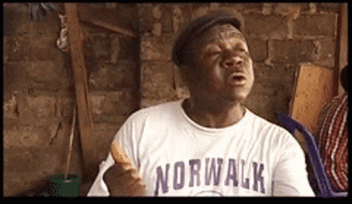 A Man Wearing A Norwalk Shirt Holds A Sandwich GIF