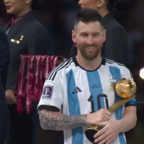 A Man Wearing A Number 10 Jersey Holds A Trophy GIF