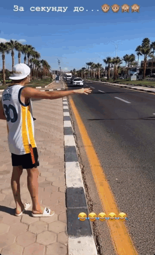 A Man Wearing A Number 30 Jersey Is Standing On The Side Of A Road GIF