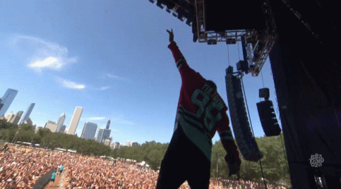 A Man Wearing A Number 98 Jersey Stands On Stage GIF