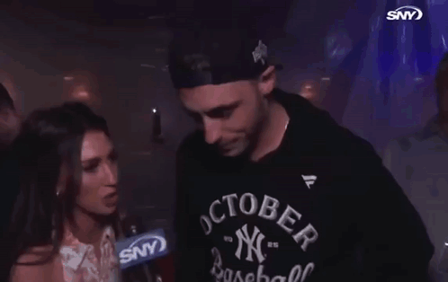 A Man Wearing A Ny Baseball Shirt Is Being Interviewed GIF