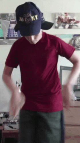 A Man Wearing A Ny Hat And A Red Shirt GIF