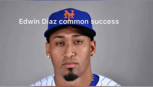 A Man Wearing A Ny Hat With The Words Edwin Diaz Common Success On The Bottom GIF
