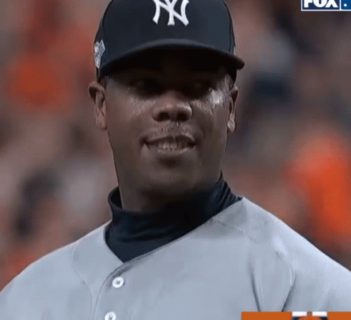 A Man Wearing A Ny Yankees Hat And Jersey GIF