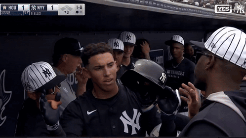 A Man Wearing A Ny Yankees Jersey Stands In A Dugout GIF