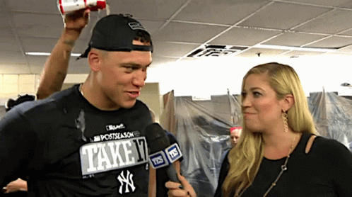 A Man Wearing A Ny Yankees Shirt Is Interviewed By A Woman GIF