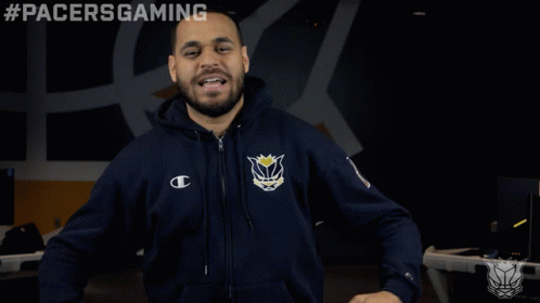 A Man Wearing A Pacers Gaming Hoodie Stands In Front Of A Black Background GIF