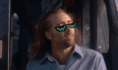 A Man Wearing A Pair Of Pixelated Sunglasses Looks To His Left GIF