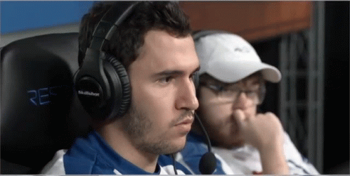 A Man Wearing A Pair Of Skullbox Headphones Sits In A Chair GIF