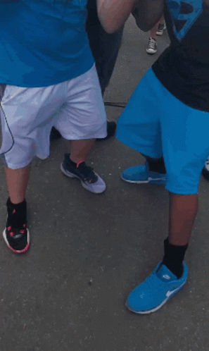 A Man Wearing A Panthers Shirt Stands Next To Another Man Wearing A Mask GIF
