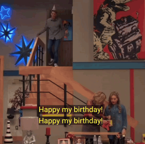 A Man Wearing A Party Hat Is Walking Down A Set Of Stairs And Says " Watch Out Watch Out For What " GIF