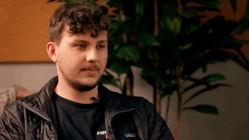 A Man Wearing A Patagonia Jacket And A Shirt With The Word Min On It GIF