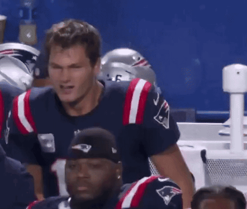 A Man Wearing A Patriots Jersey Stands In A Huddle GIF