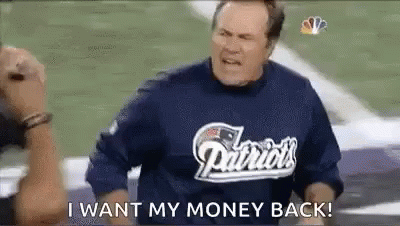 a man wearing a patriots shirt is standing on a football field and saying `` i want my money back '' .