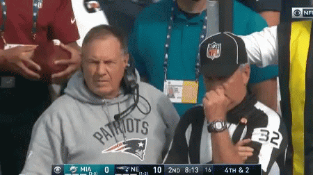 A Man Wearing A Patriots Sweatshirt Is Covering His Nose GIF