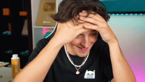 A Man Wearing A Pearl Necklace And A Black Shirt With A Cat On It GIF