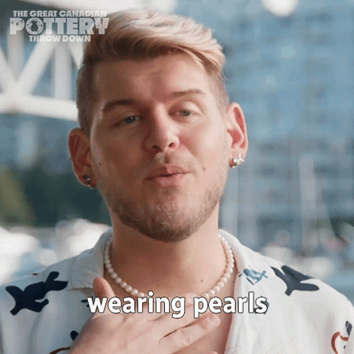 A Man Wearing A Pearl Necklace With The Words Wearing Pearls Written On It GIF