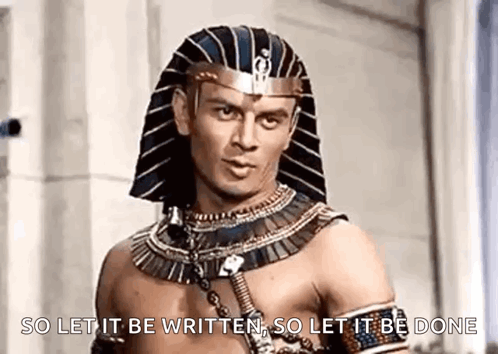 A Man Wearing A Pharaoh 'S Hat Is Standing In Front Of A Wall . GIF