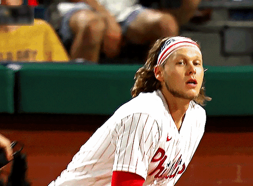 A Man Wearing A Phillies Jersey With A Headband On GIF