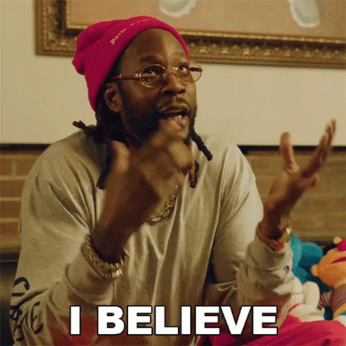 A Man Wearing A Pink Beanie And Glasses Is Saying I Believe GIF