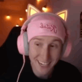 a man wearing a pink hat and pink headphones is smiling .