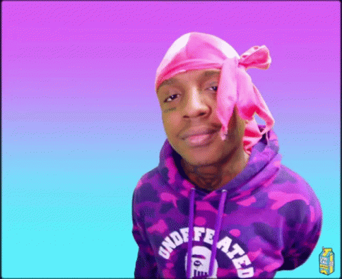 A Man Wearing A Pink Headband And A Purple Hoodie With The Word Undefeated On It GIF