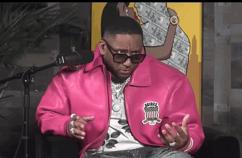 A Man Wearing A Pink Jacket With The Word Rider On The Back GIF
