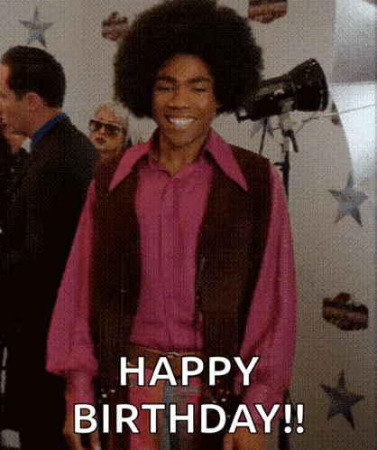 A Man Wearing A Pink Shirt And A Brown Vest Is Smiling And Says Happy Birthday GIF