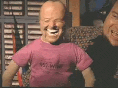 A Man Wearing A Pink Shirt That Says 912 Wine GIF