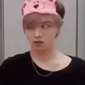 A Man Wearing A Pink Teddy Bear Hat And A Black Shirt . GIF