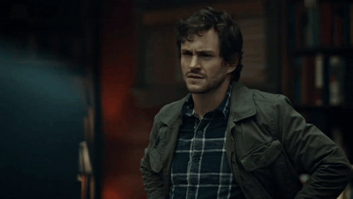 A Man Wearing A Plaid Shirt And A Green Jacket GIF