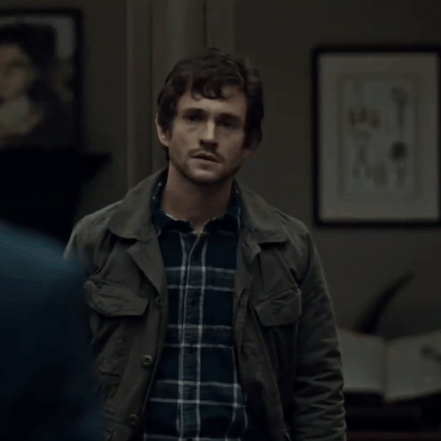 A Man Wearing A Plaid Shirt And A Green Jacket GIF