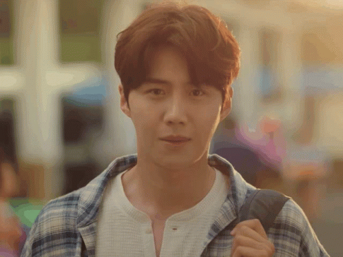 A Man Wearing A Plaid Shirt And A White Shirt Is Carrying A Backpack GIF