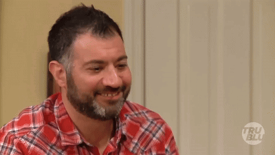 A Man Wearing A Plaid Shirt Is Asking Who Are You GIF