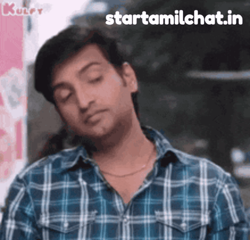A Man Wearing A Plaid Shirt Is Making A Funny Face With The Words Starttamilchat.in Written Below Him GIF