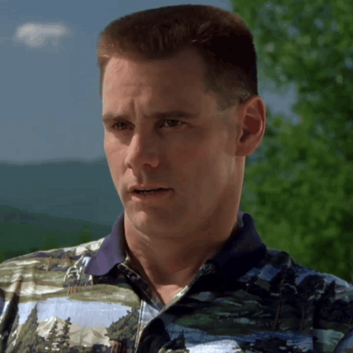 A Man Wearing A Polo Shirt With A Picture Of Trees On It GIF