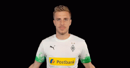 A Man Wearing A Postbank Shirt Holds His Arms Out GIF