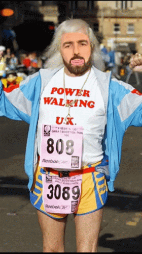 A Man Wearing A Power Walking Shirt And Reebok Shorts GIF