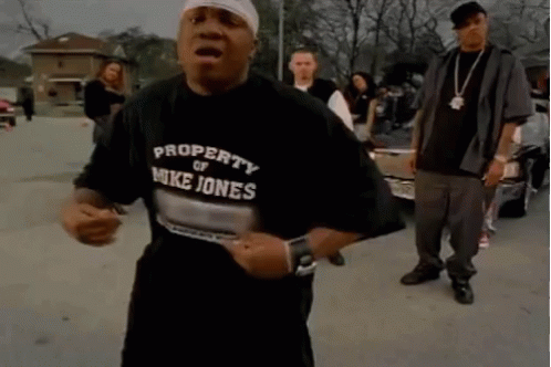A Man Wearing A Property Of Mike Jones Shirt GIF