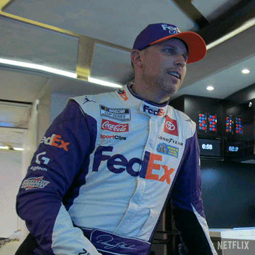 A Man Wearing A Purple And White Fedex Outfit GIF