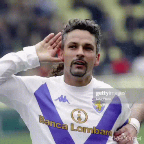 A Man Wearing A Purple And White Jersey That Says Banca Lombard GIF