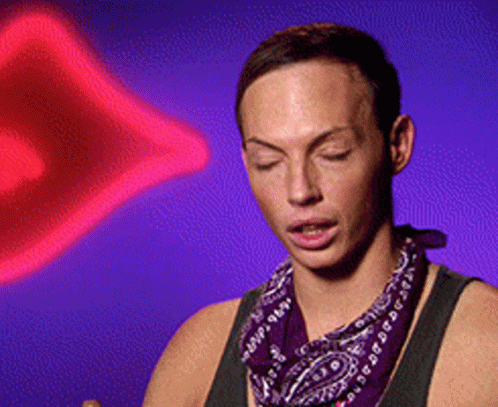 A Man Wearing A Purple Bandana Is Standing In Front Of A Purple Background GIF
