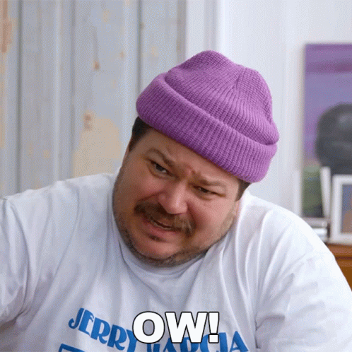 A Man Wearing A Purple Beanie And A White Shirt That Says Jerry GIF