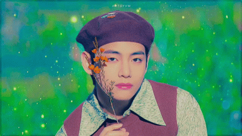 A Man Wearing A Purple Beret Is Holding A Flower GIF