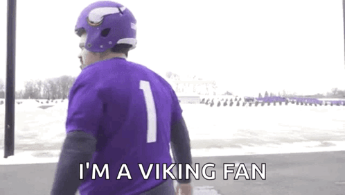 A Man Wearing A Purple Jersey And A Purple Helmet Says `` I 'M A Viking Fan '' GIF