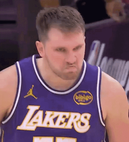 A Man Wearing A Purple Lakers Jersey Makes A Face GIF