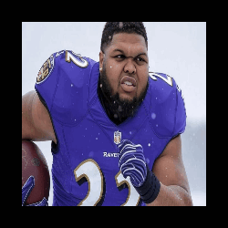 a man wearing a purple ravens jersey is holding a football